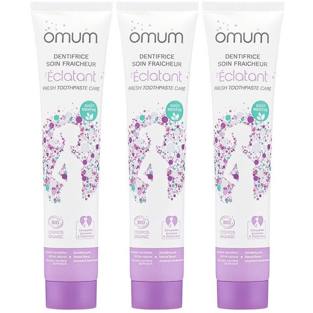 Trois tubes de dentifrice Omum Soin Fraîcheur, saveur menthe, avec un motif de points violets et verts.