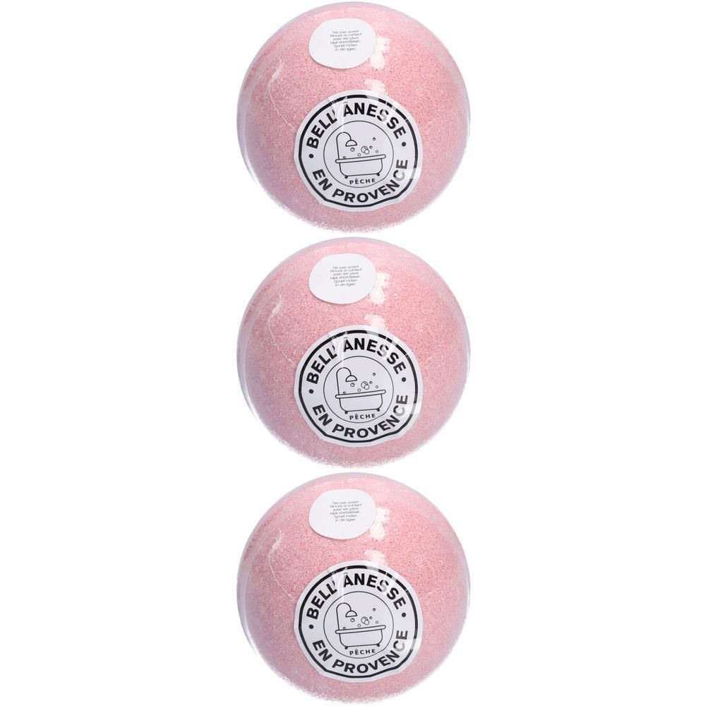 Trois boules de bain roses parfum pêche, emballées sous film avec des étiquettes rondes.