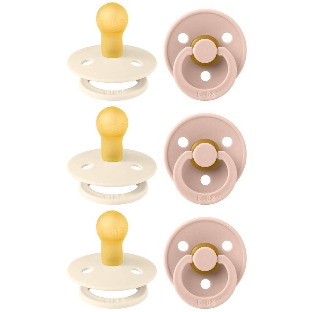 Trois tétines couleur crème et trois tétines rose avec tétine jaune et bouclier blanc.