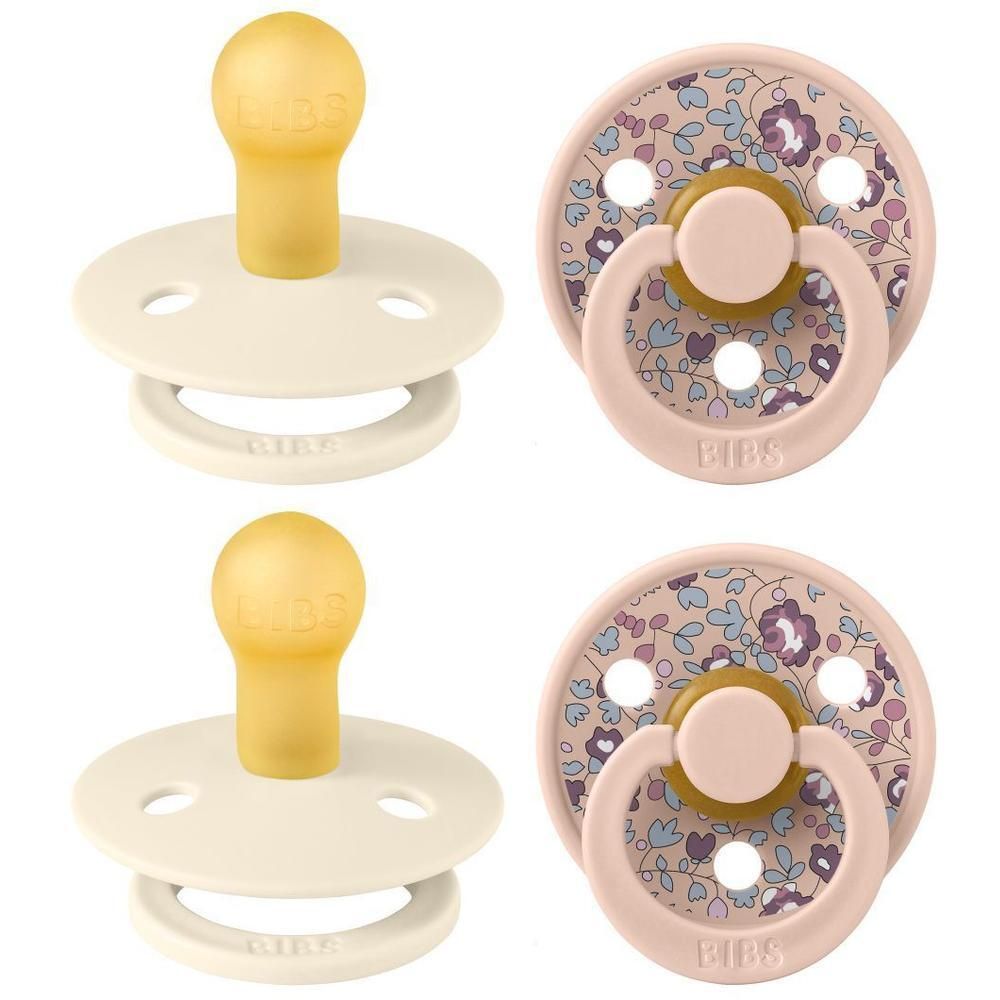 Deux sucettes BIBS : une couleur crème et une rose à motif floral.