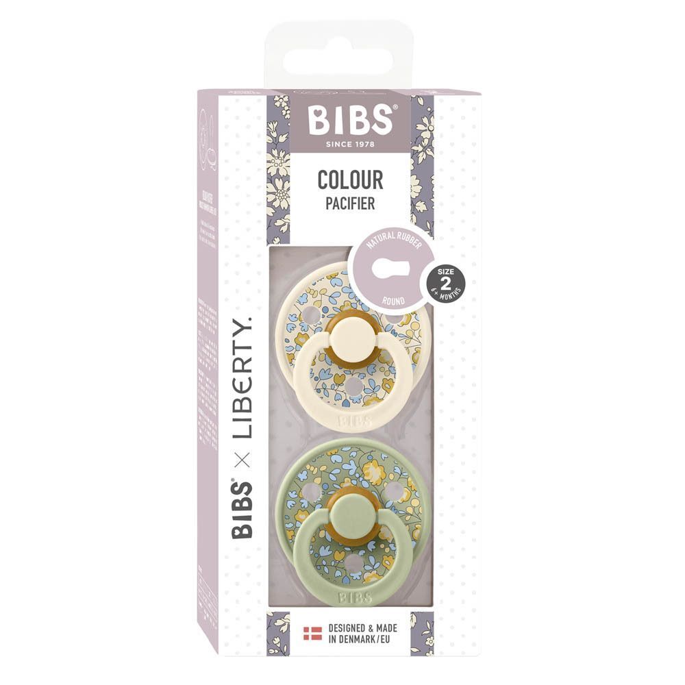Deux sucettes BIBS dans leur emballage : une crème et une vert clair à motif floral.