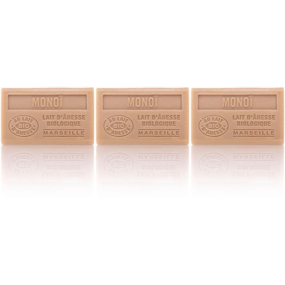Trois savons rectangulaires marqués MONOI, AU LAIT D'ÂNESSE BIOLOGIQUE, MARSEILLE.