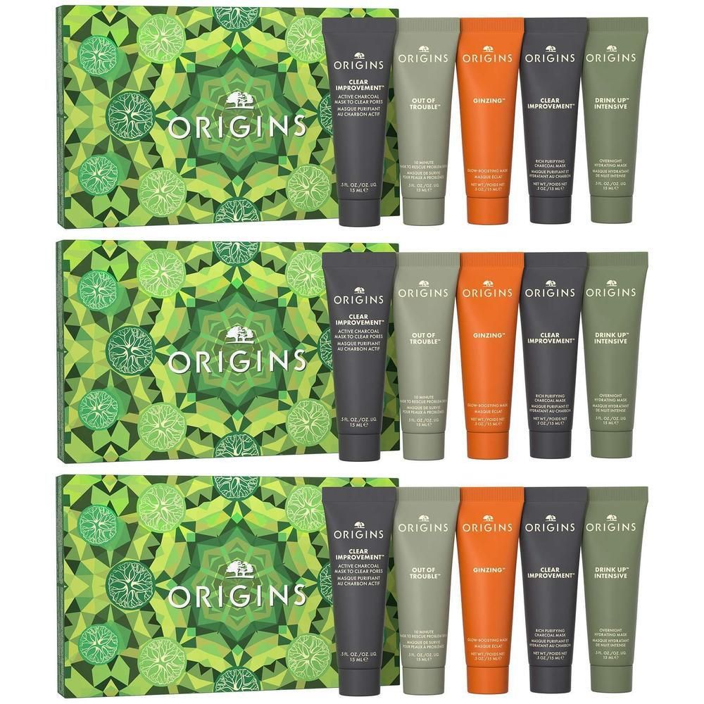 Coffret cadeau Origins avec 5 produits de soins pour le visage et le corps en tubes et une boîte décorative.