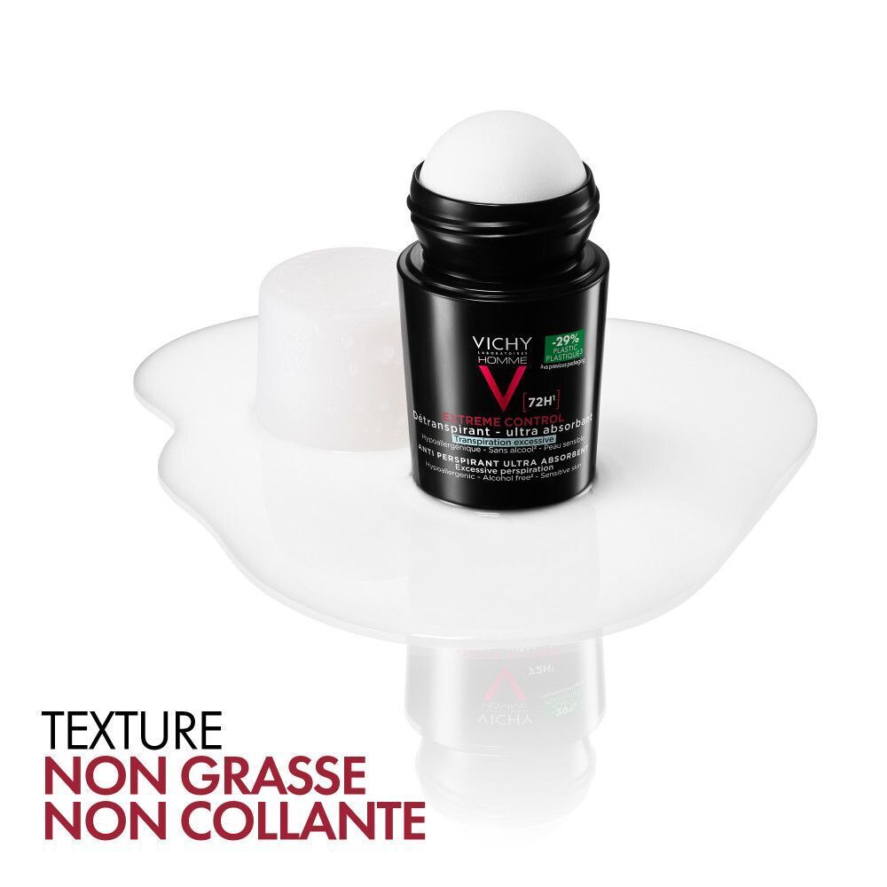 Un roll-on déodorant Vichy Homme ouvert, bille exposée, sur une surface blanche.