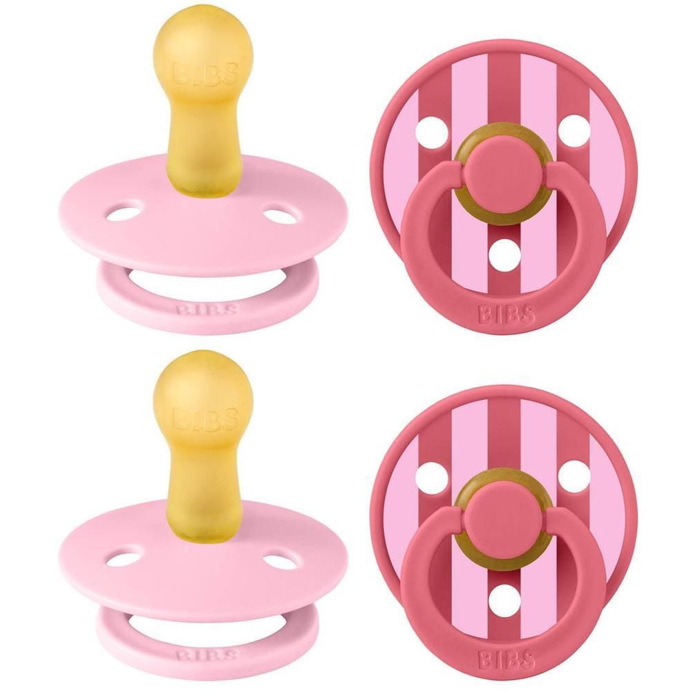 Deux sucettes BIBS roses avec tétine en caoutchouc naturel jaune et anneau rose.