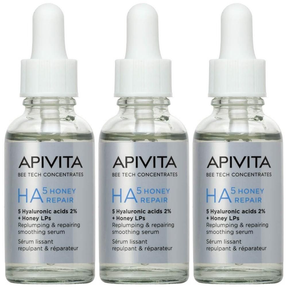 Trois flacons de sérum Apivita HA5 Honey Repair avec compte-gouttes.