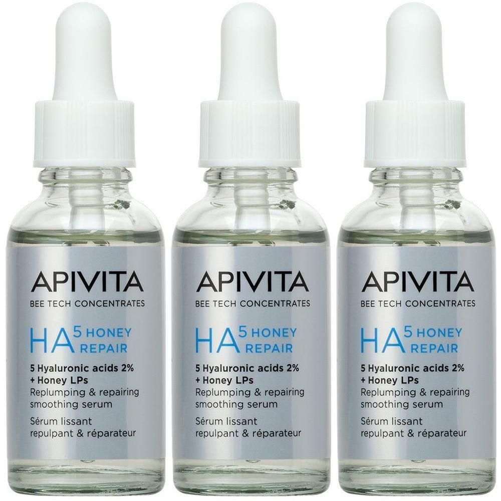 Drie flacons Apivita HA5 Honey Repair serum met pipetten.