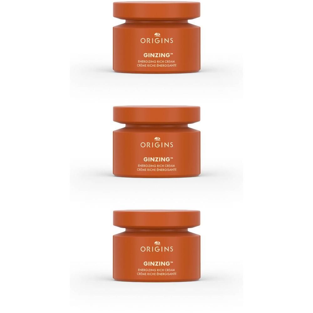 Trois pots de crème Origins Ginzing Energizing Rich Cream de couleur orange.