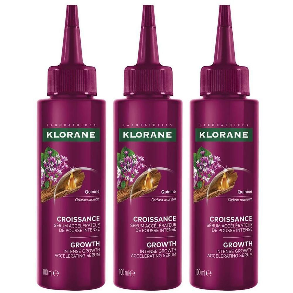 Drie Klorane Groei serums in donkerpaarse flacons met applicator.