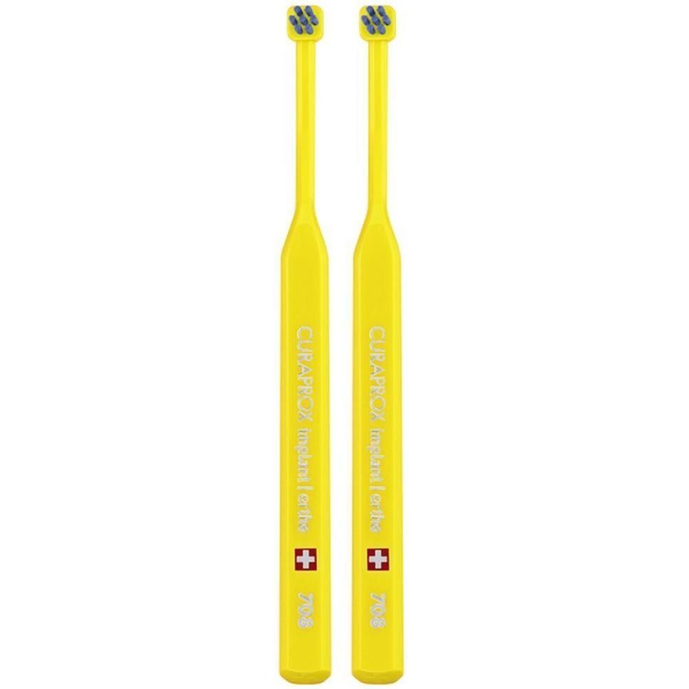Deux brosses à dents jaunes avec des têtes étroites et de petites soies.