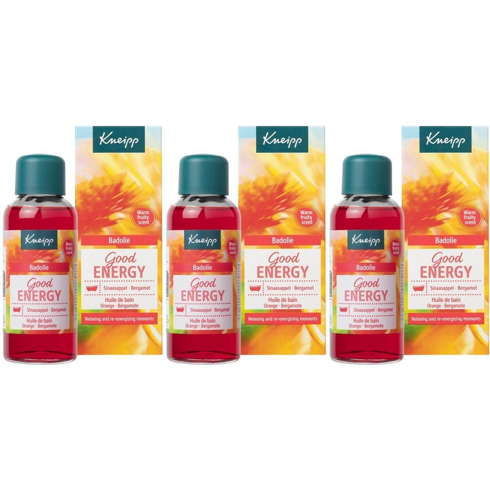 Drie flessen Kneipp Good Energy Badolie met oranje en gele bloemen op de achtergrond.
