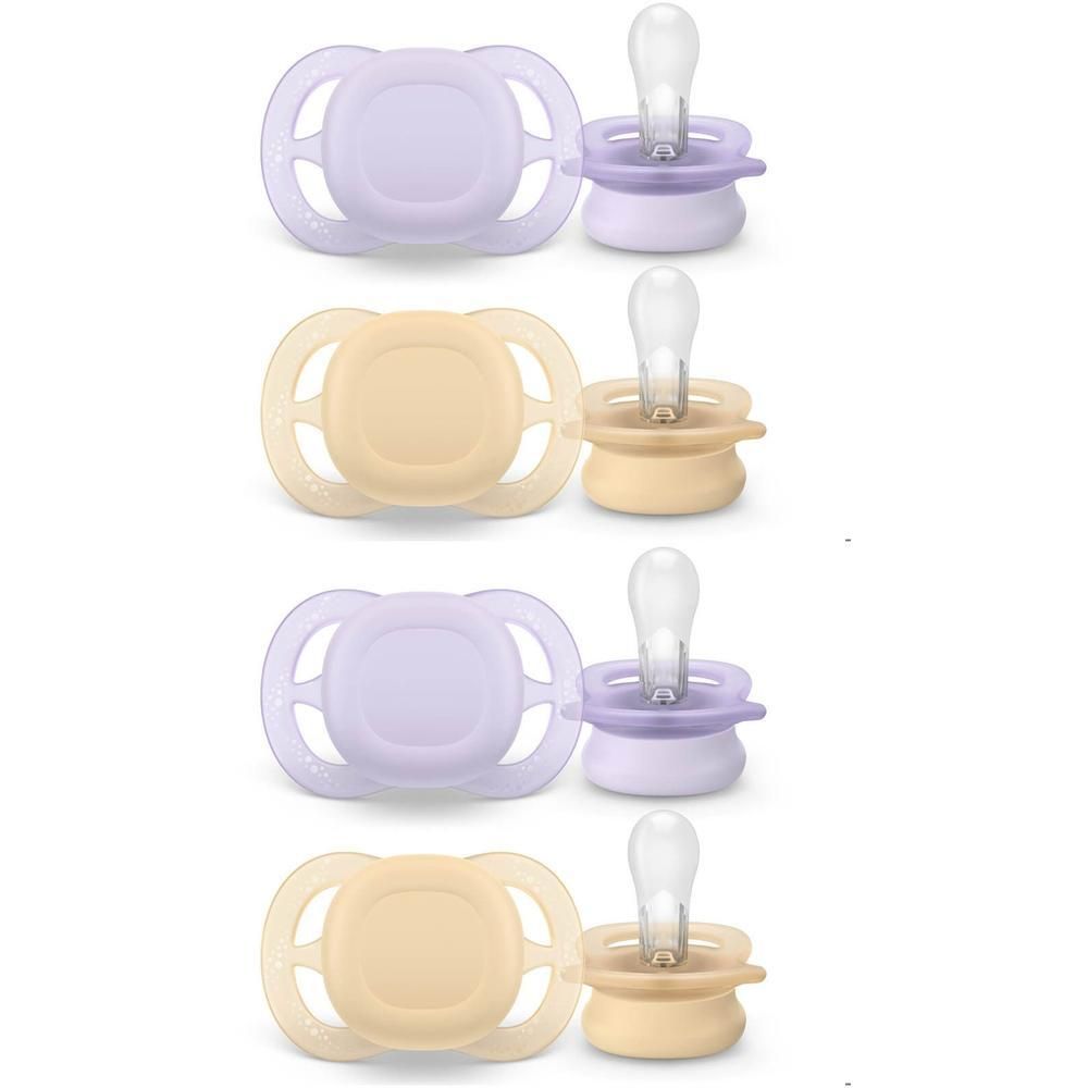 Quatre sucettes lilas et jaunes, chacune avec un capuchon de protection.
