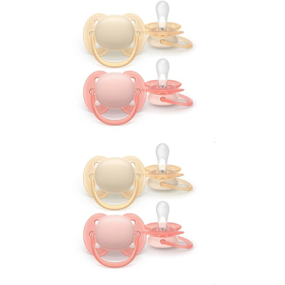 Quatre sucettes, deux beiges et deux roses.