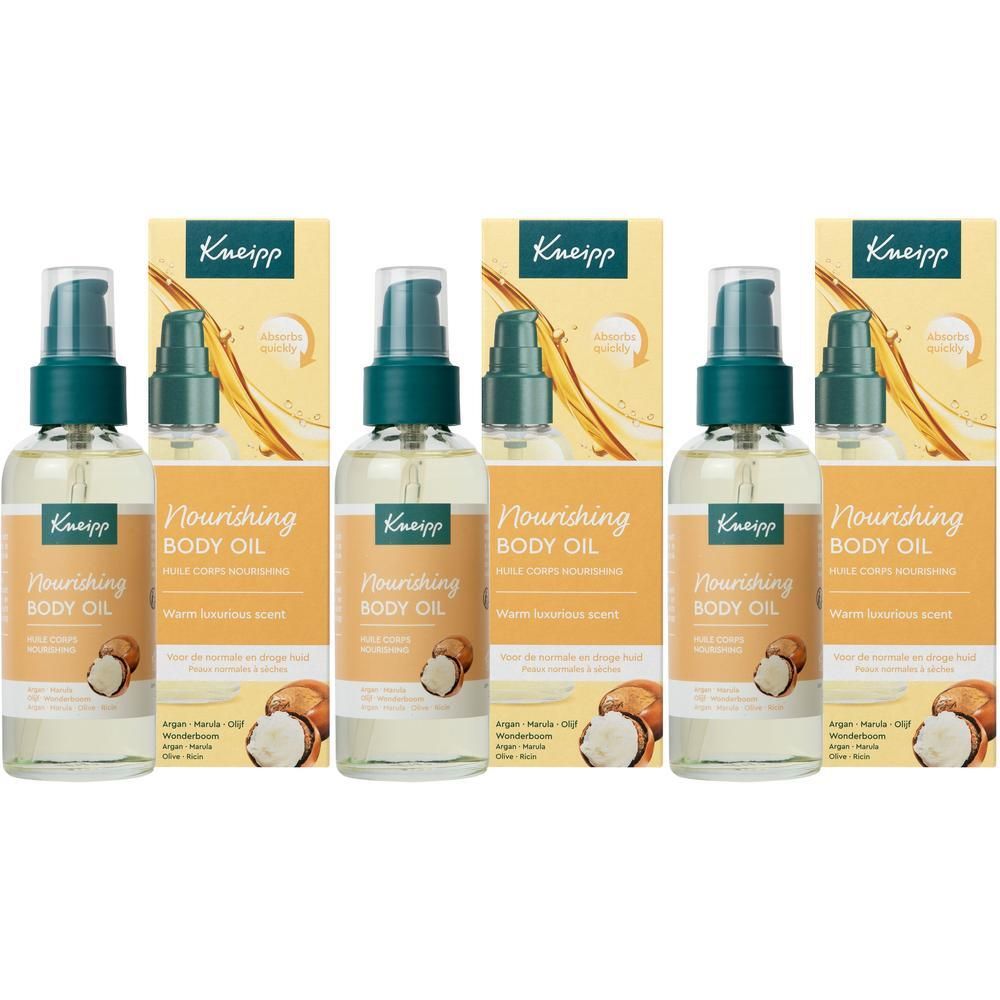 Quatre flacons d'huile corporelle Kneipp avec pompe. Huile jaune dans des flacons transparents avec étiquette orange et jaune.