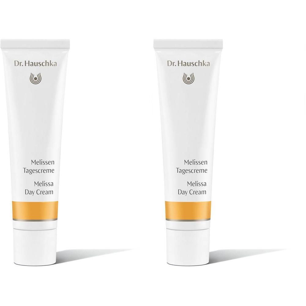 Twee witte tubes Dr. Hauschka Melisse Dagcrème met gouden band.