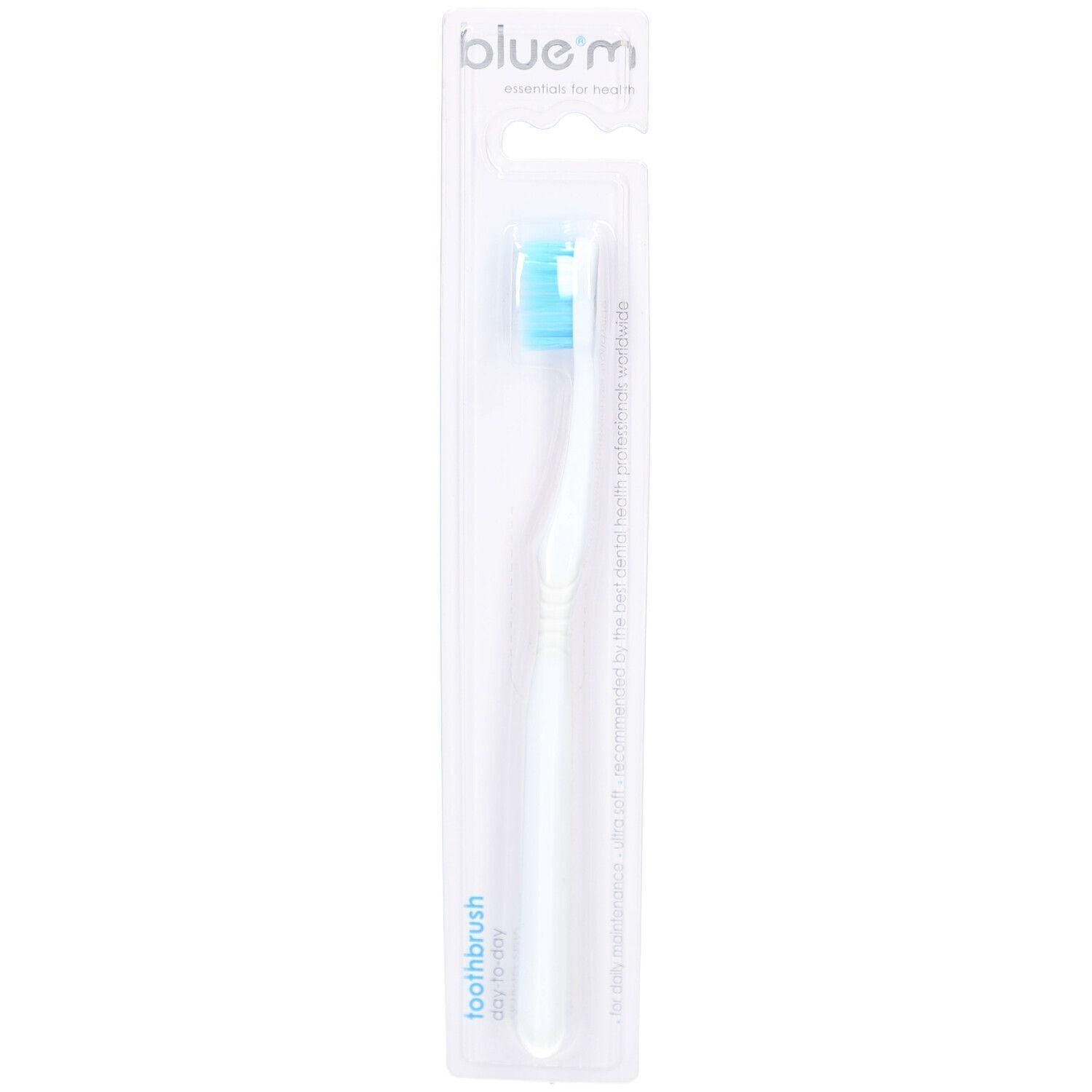 Brosse à dents blanche avec tête bleue, emballée.