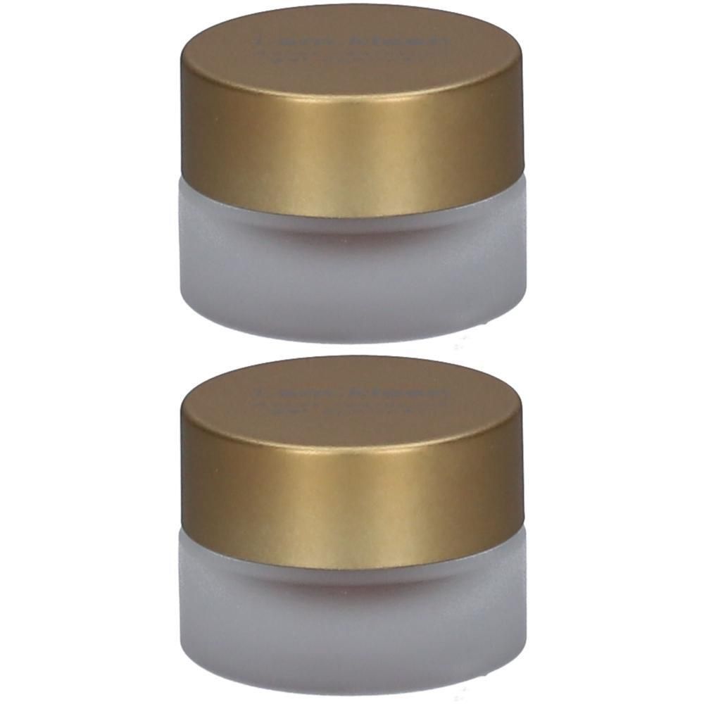 Twee kleine potjes van mat glas met gouden deksels.