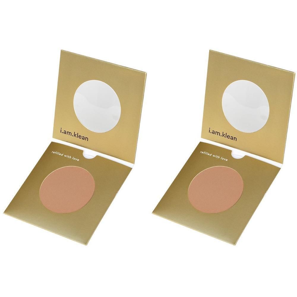 Twee open gouden doosjes met medium getinte compactpoeder.