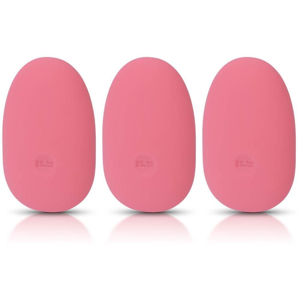 Trois vibromasseurs roses en forme d'œuf, côte à côte sur fond blanc.