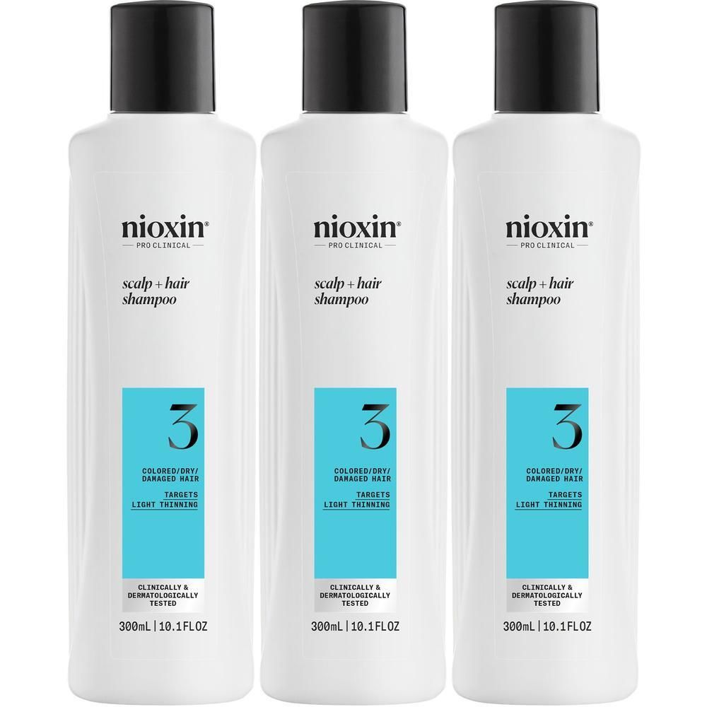 Trois bouteilles de shampooing Nioxin Système 3 pour cheveux colorés et abîmés.