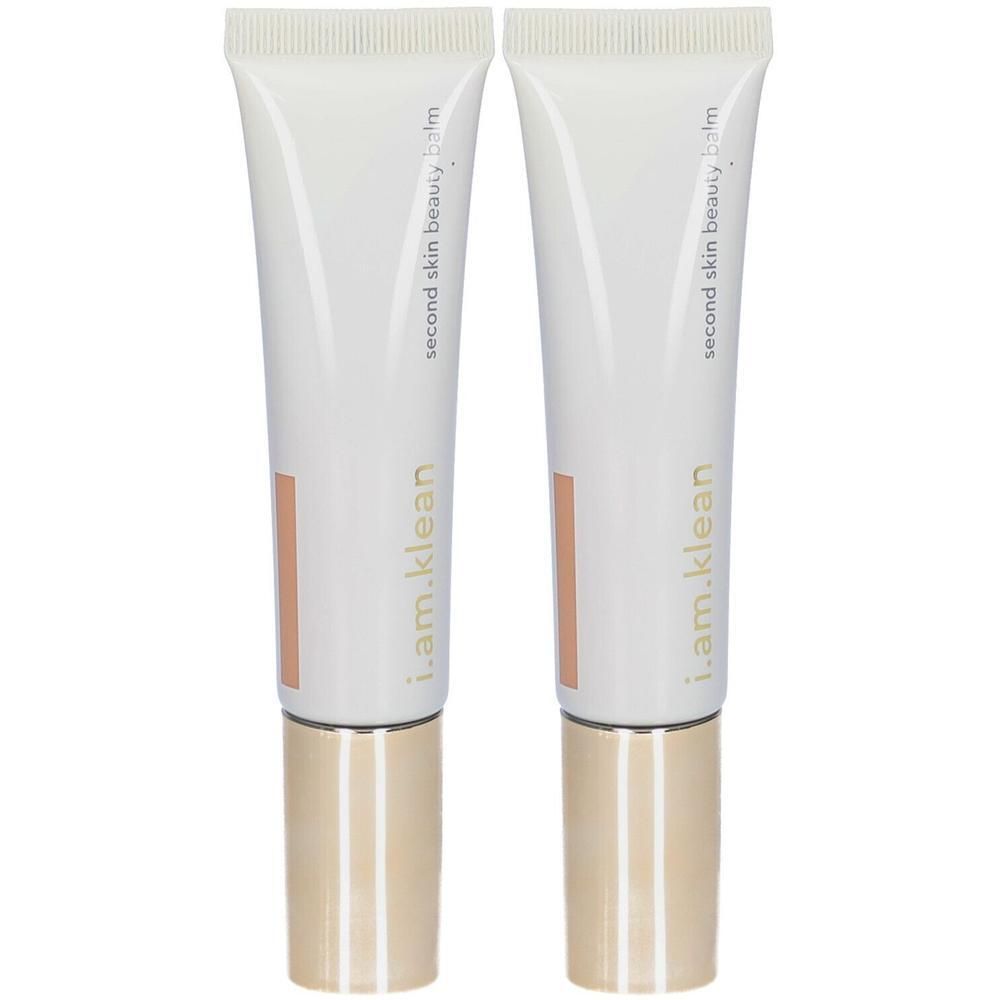 Deux tubes de i.am.klean Second Skin Beauty Balm avec bouchons dorés.