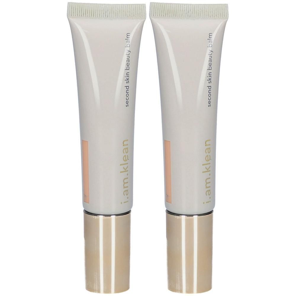 Deux tubes de i.am.klean Second Skin Beauty Balm avec bouchons dorés.