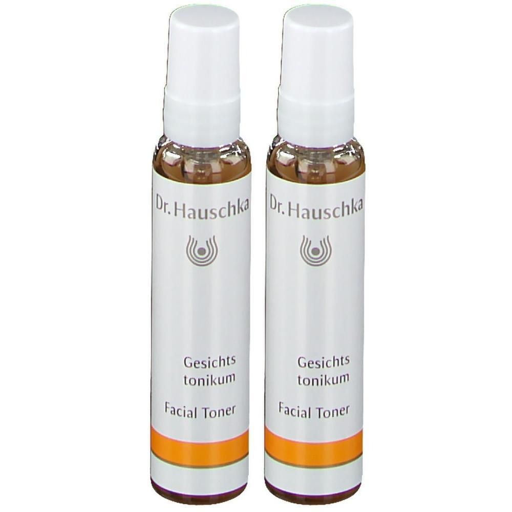 Deux flacons pulvérisateurs Dr. Hauschka Lotion Tonifiante avec bouchon blanc et bande orange.