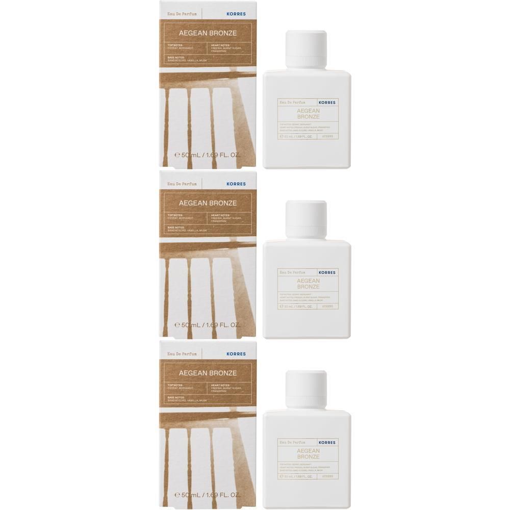 Trois flacons d'Eau de Parfum Korres avec leurs boîtes. Flacons blancs avec étiquettes indiquant 'Aegean Bronze'.
