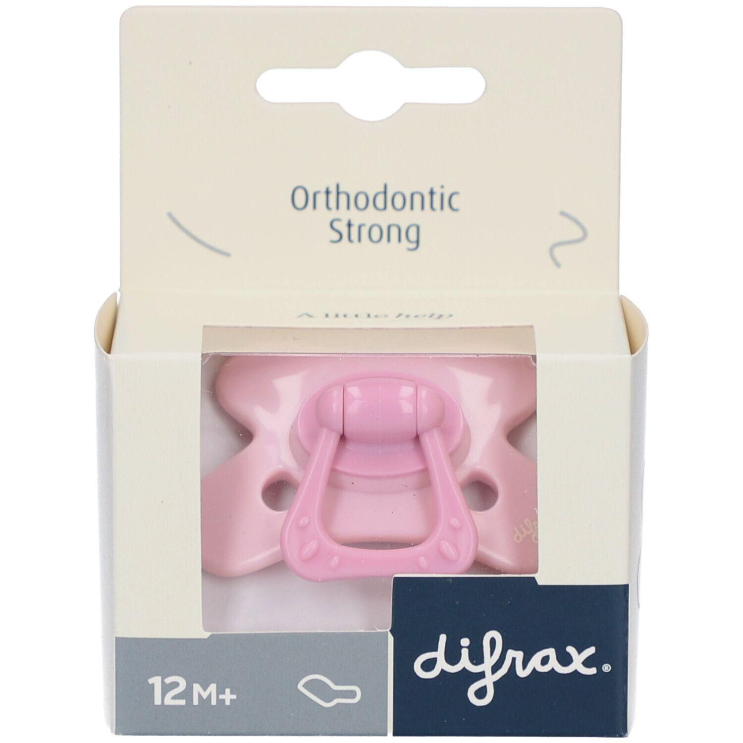 Une sucette orthodontique rose pour bébés de 12 mois et plus, dans son emballage.