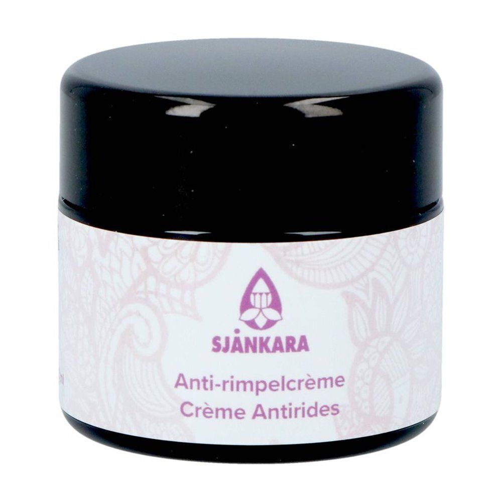 Un pot de crème anti-rides Sjankara. Pot de 50 ml avec couvercle noir et étiquette blanche avec logo violet.
