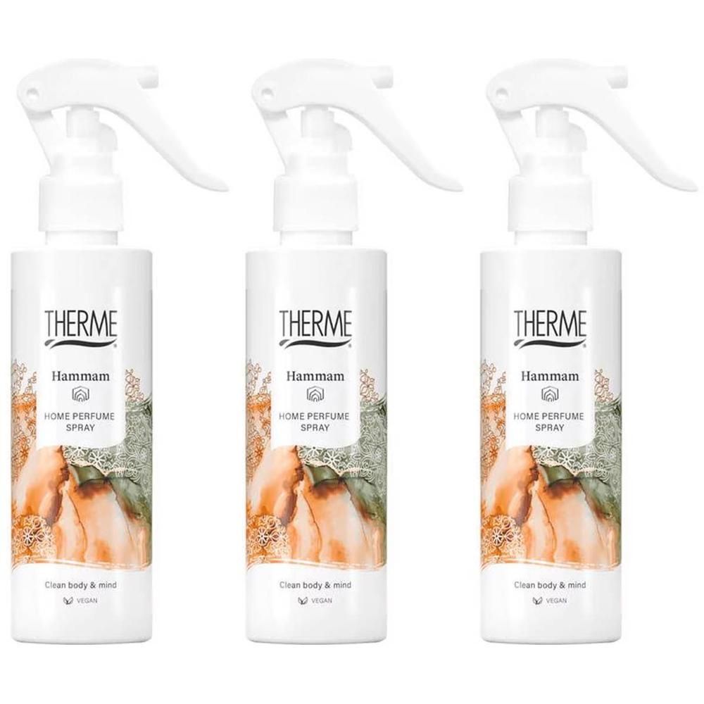 Drie witte spuitflessen van Therme Hammam Home Perfume Spray. Elke fles heeft een etiket met een afbeelding van sinaasappels en groene bladeren.