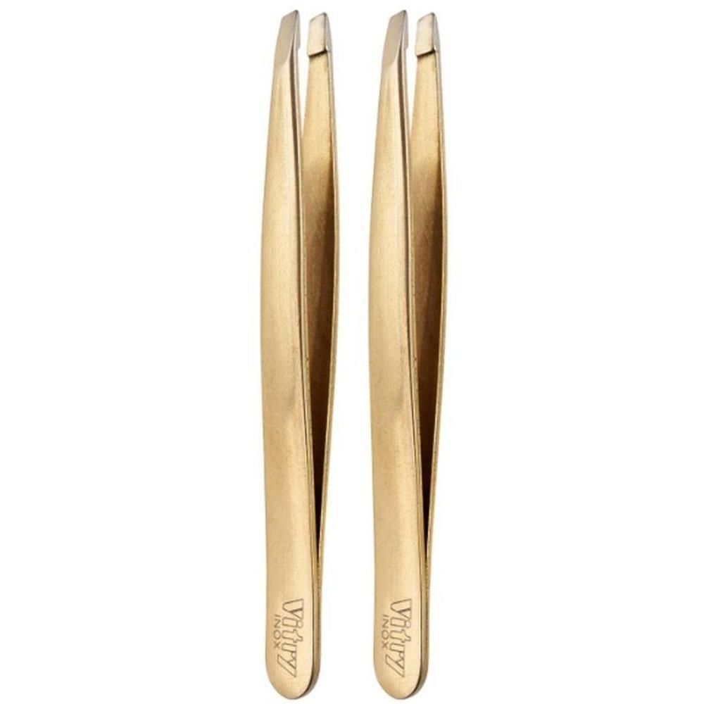 Twee gouden pincetten met taps toelopende punten.