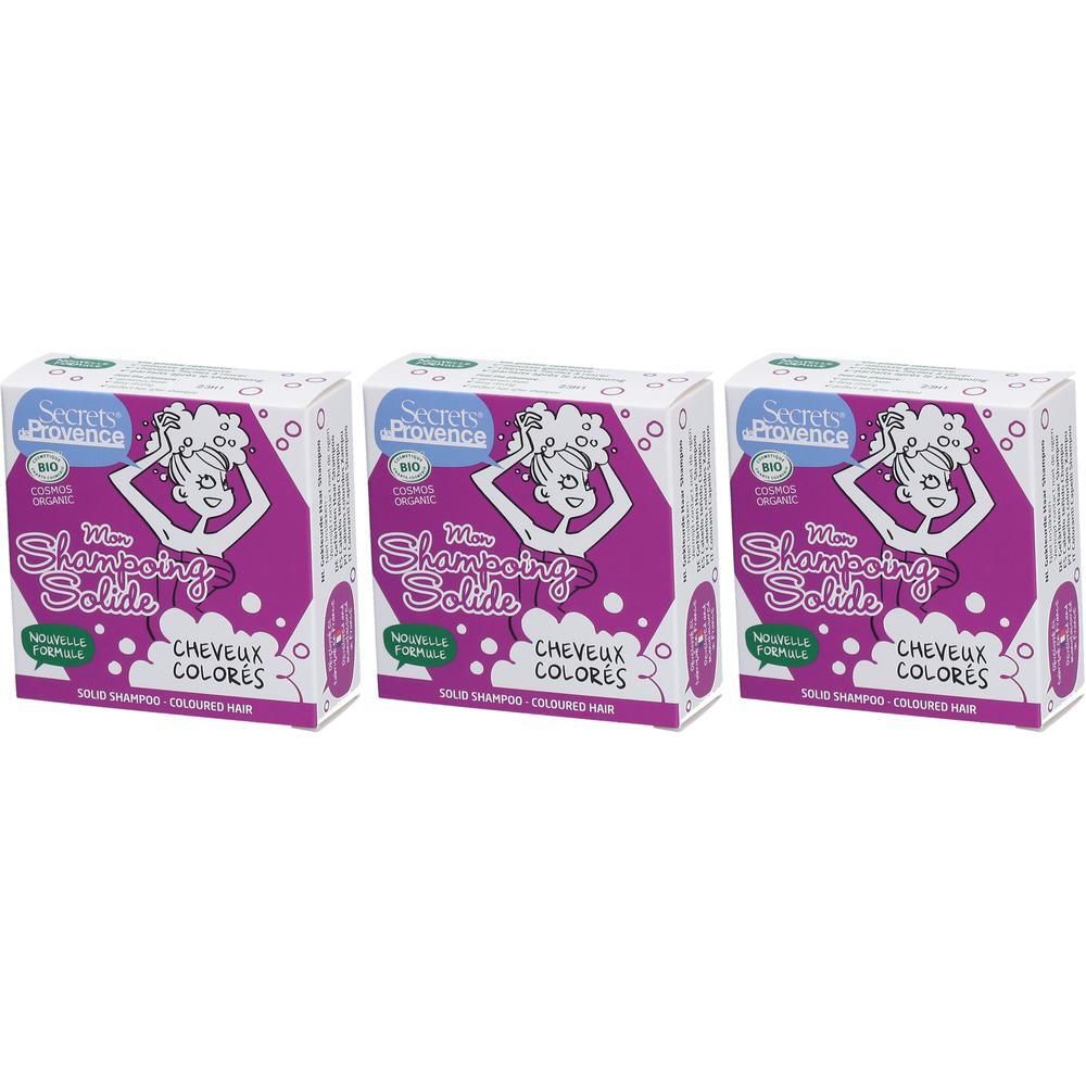 Drie dozen Secrets de Provence vaste shampoo voor gekleurd haar. Paarse verpakking met illustratie van een vrouw die haar wast.