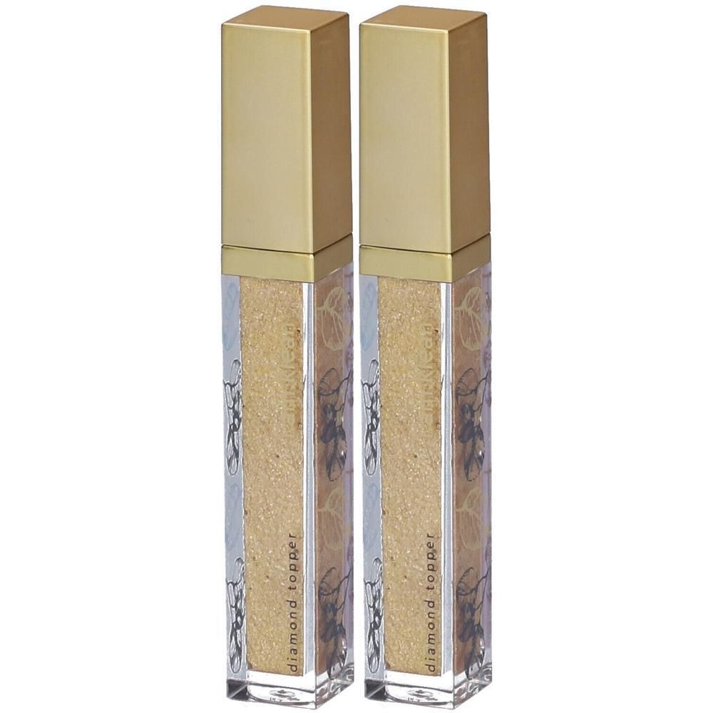 Twee gouden applicators met glinsterende inhoud en bloemenpatroon.