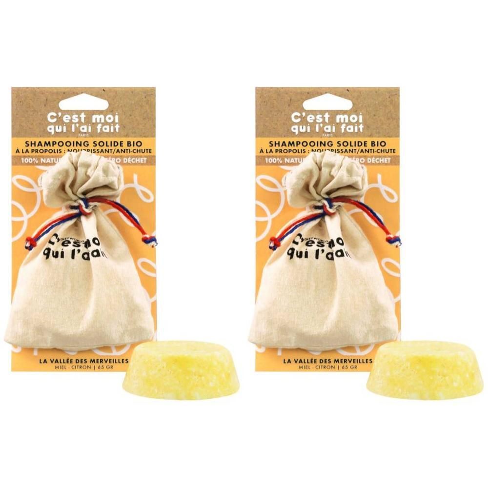 Twee vaste biologische shampoos met propolis in zakjes, met daarnaast twee gele shampoo stukken.