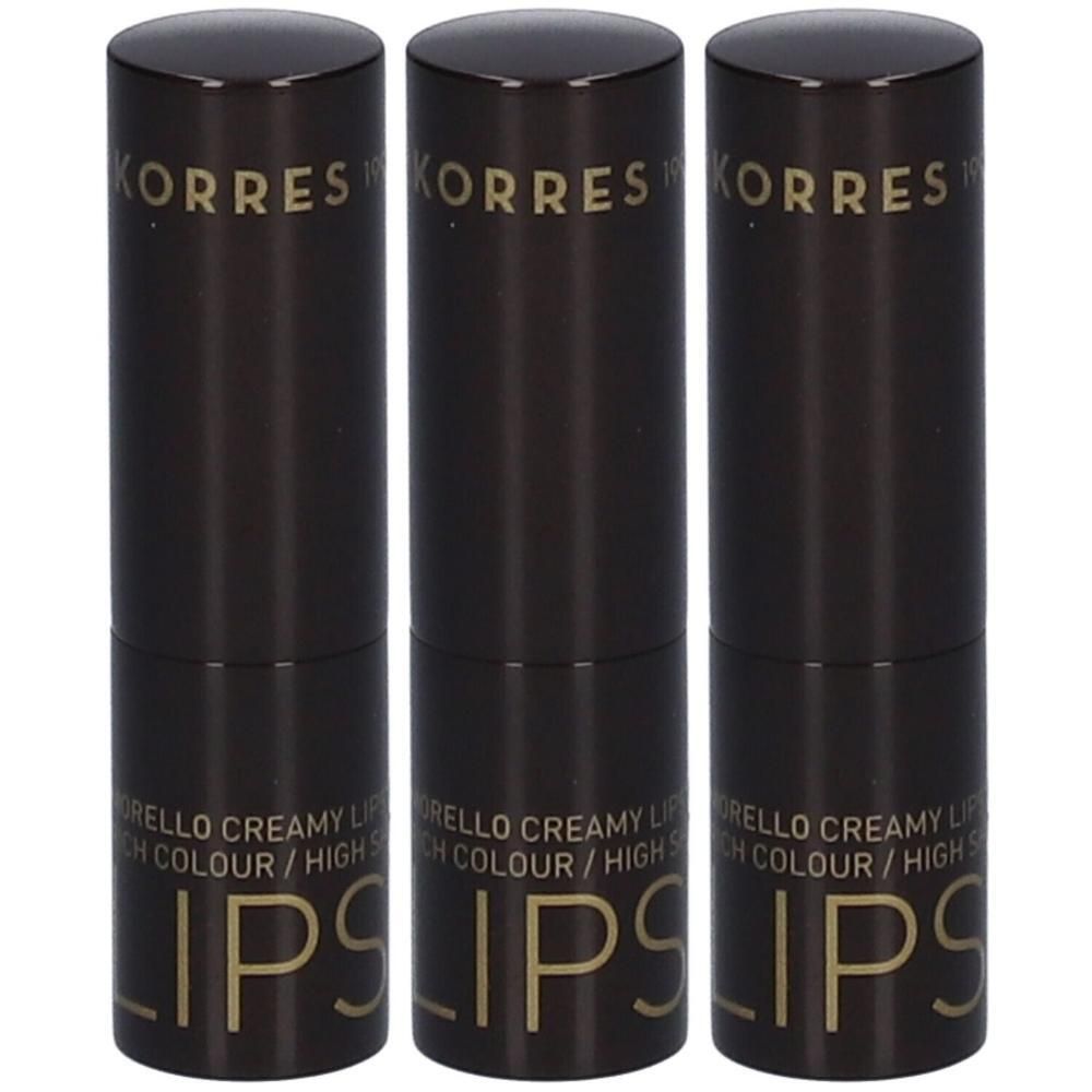 Drie Korres lippenstiften in donkere verpakking met gouden opdruk.