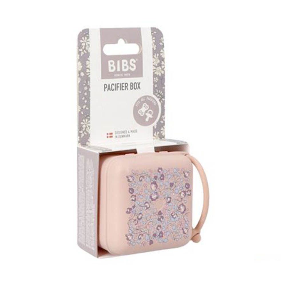 Boîte à sucettes BIBS rose à motif floral, dans son emballage.