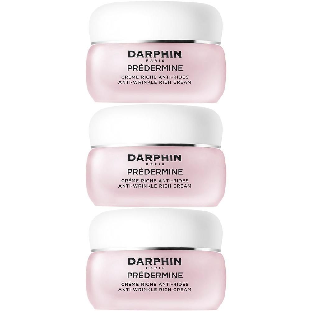 Trois pots de crème Darphin Prédermine anti-rides empilés. Pots roses avec couvercles blancs.