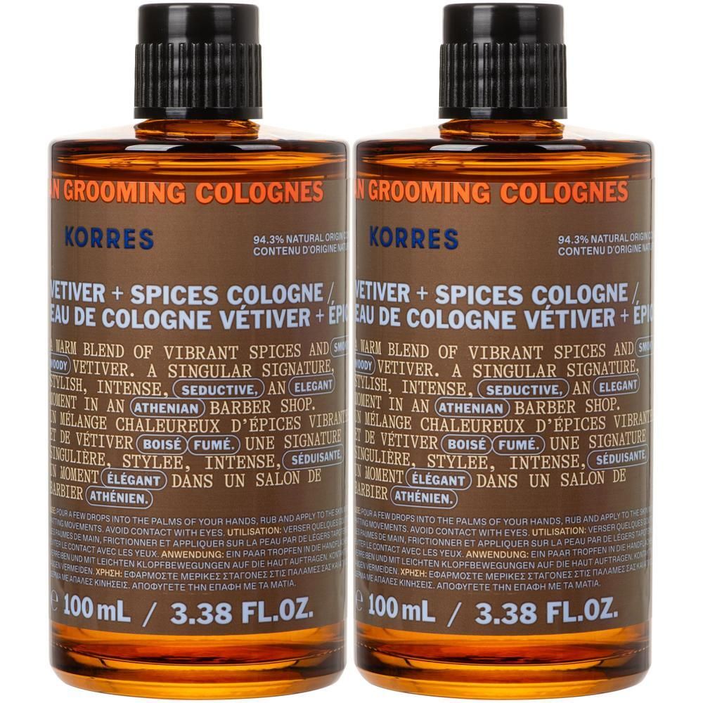 Twee flessen Korres Vétiver + Kruiden Eau de Cologne. Bruine glazen flessen met zwarte doppen.