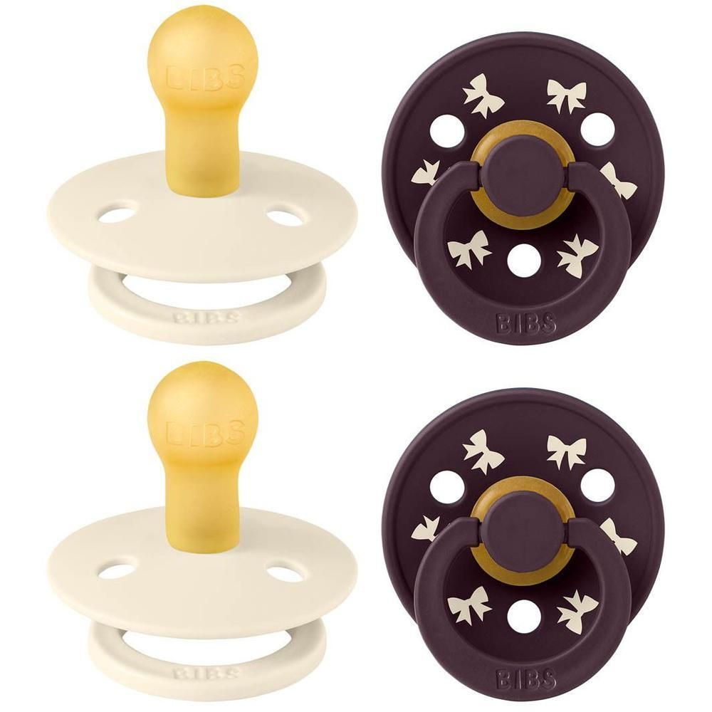 Deux BIBS sucettes: deux crème avec tétine jaune, deux aubergine avec motif nœud et anneau jaune.
