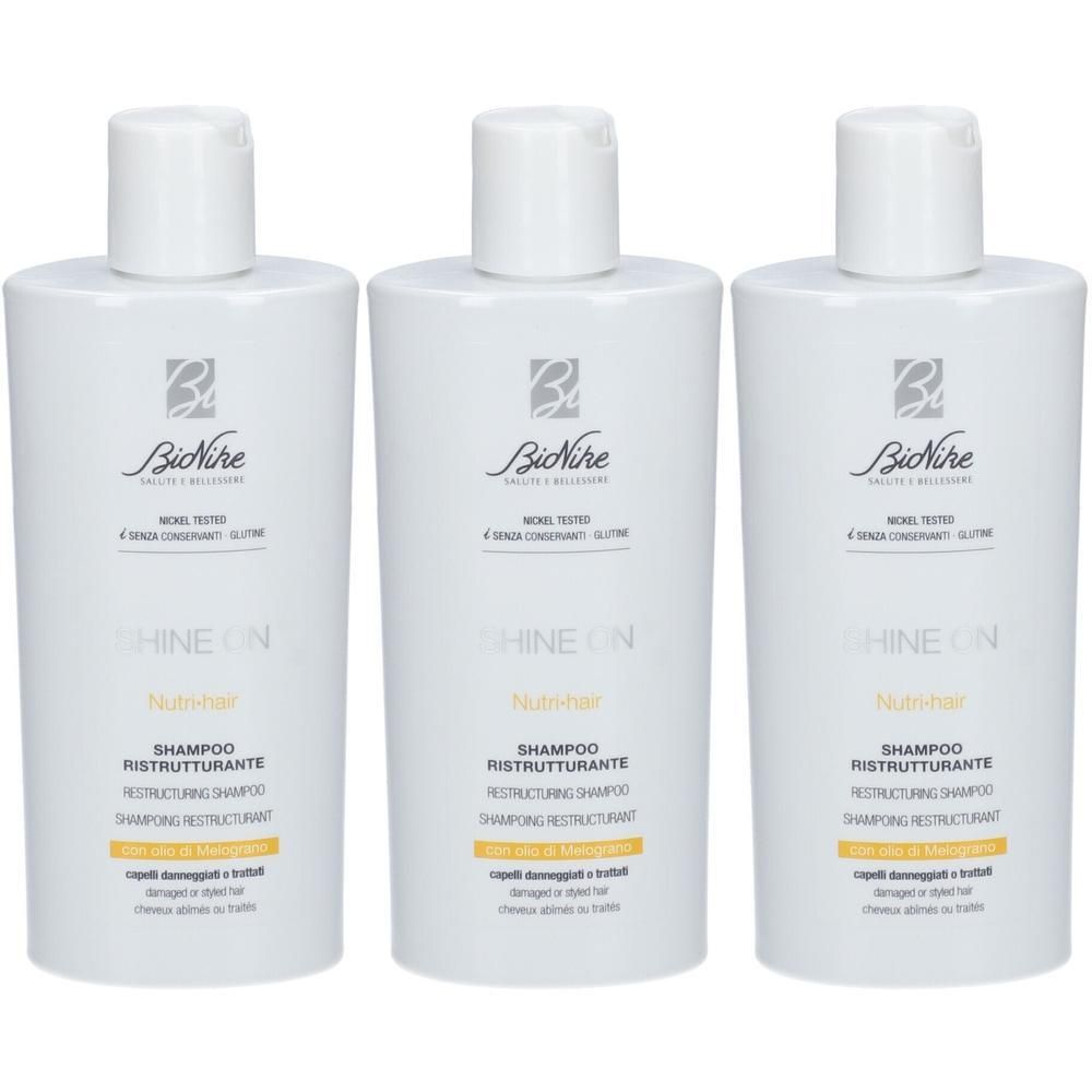 Drie witte flessen Bionike Shine On Nutrihair Shampoo. Voor beschadigd haar.