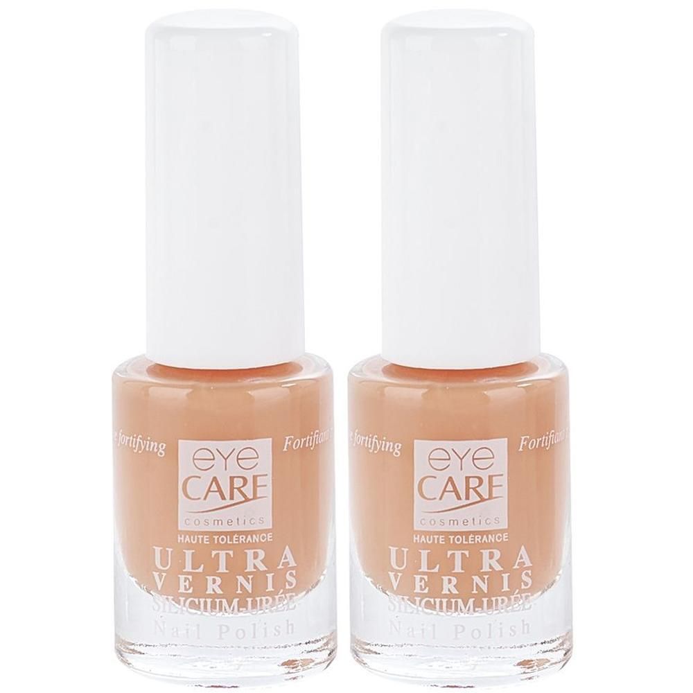 Twee flacons Eye Care Ultra Vernis nagellak in koraalkleur.