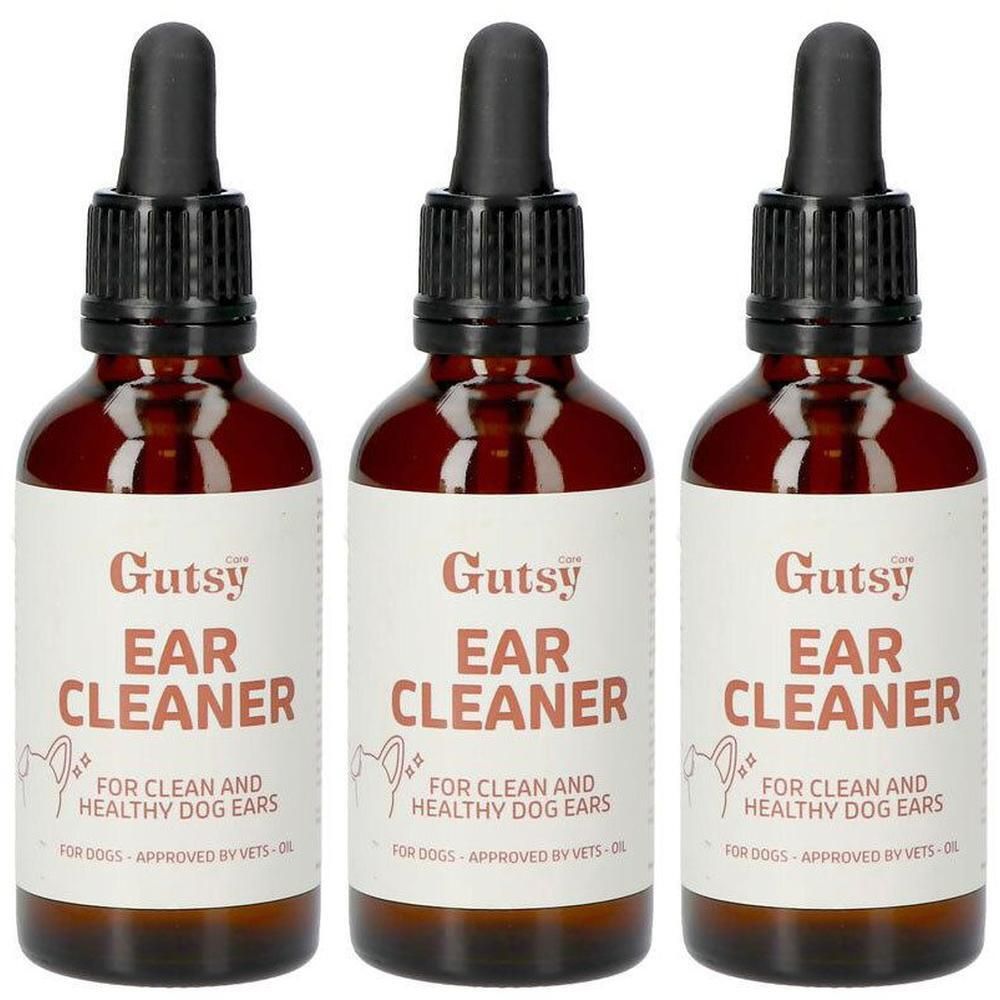 Trois flacons de nettoyant pour oreilles Gutsy pour chiens avec compte-gouttes. Verre brun, étiquettes blanches.