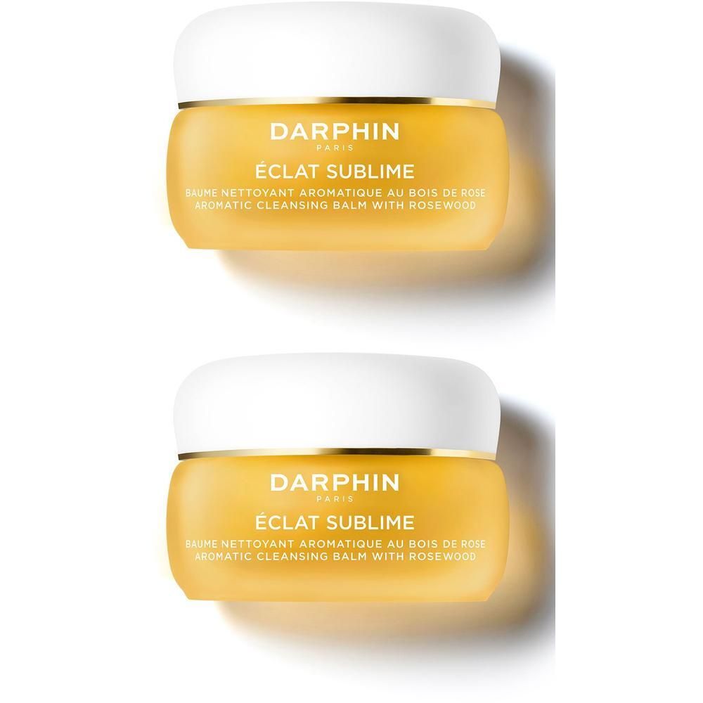 Twee Darphin Eclat Sublime reinigingsbalsem potjes met witte deksel en gouden rand. Gele kleur.