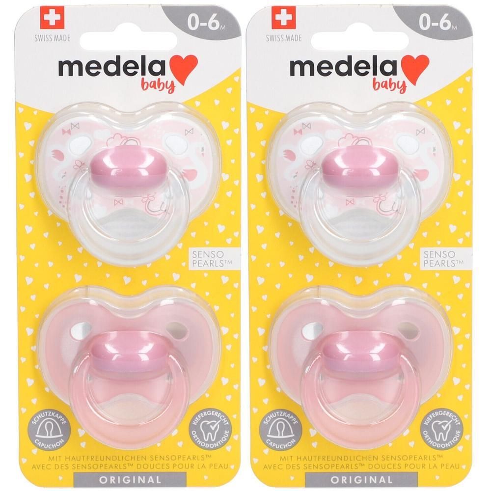 Deux sucettes Medela roses, 0-6 mois, avec capuchon protecteur et motif cœur.