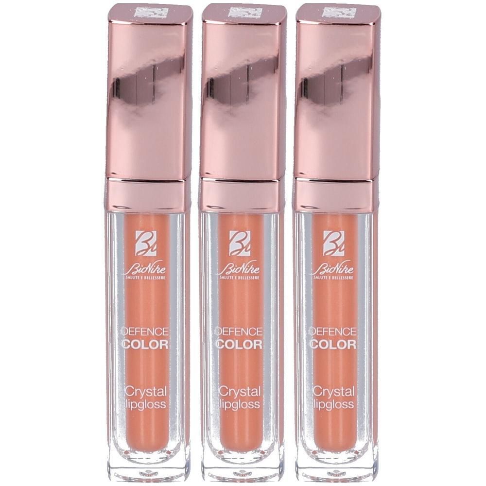 Drie BioNike Defence Color Crystal Lipgloss in perziktint met roségouden doppen.