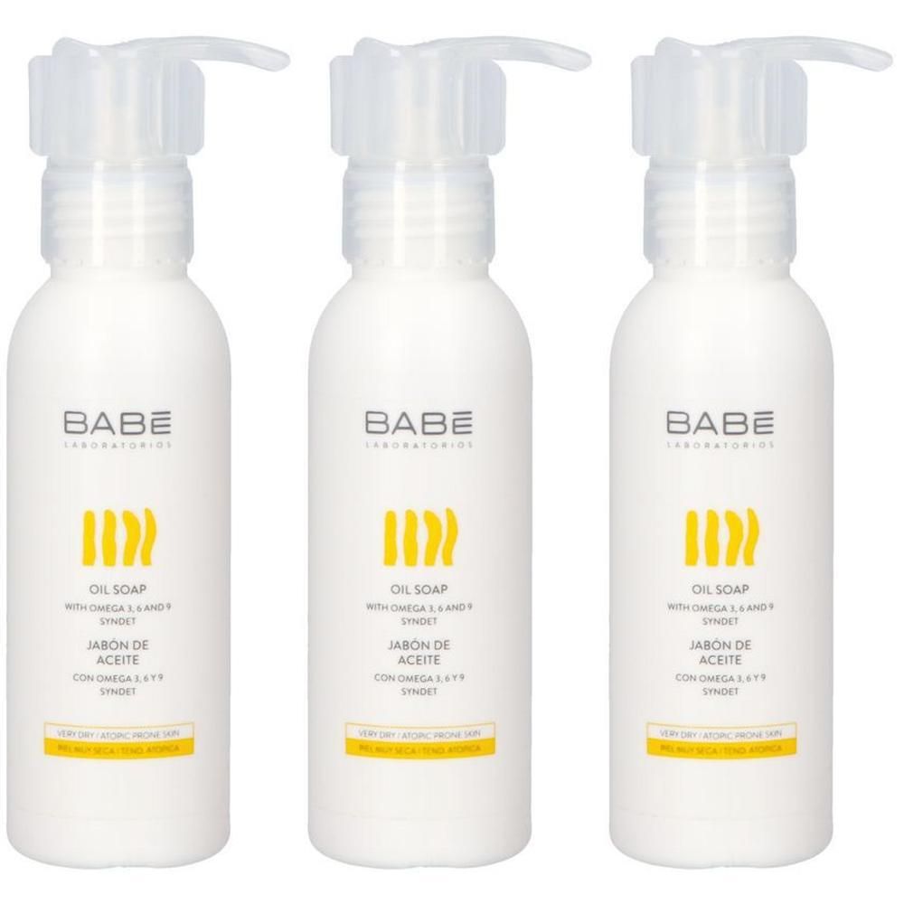 Trois flacons pompe blancs avec logo jaune et inscription 'OIL SOAP'.