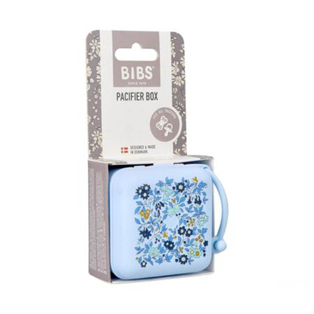 Boîte à sucettes bleu clair avec motif floral dans son emballage, marque BIBS.