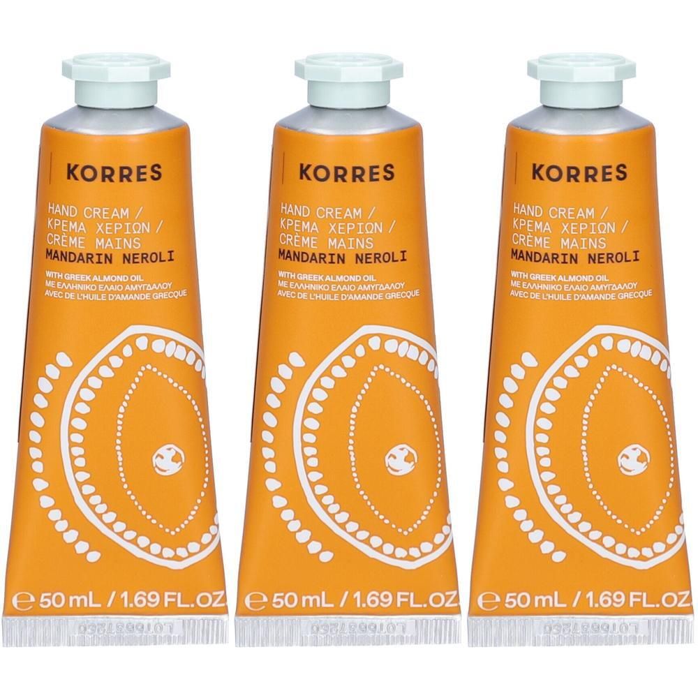 Drie Korres handcrème tubes met mandarijn en neroli. Oranje tubes met wit patroon en witte dop.