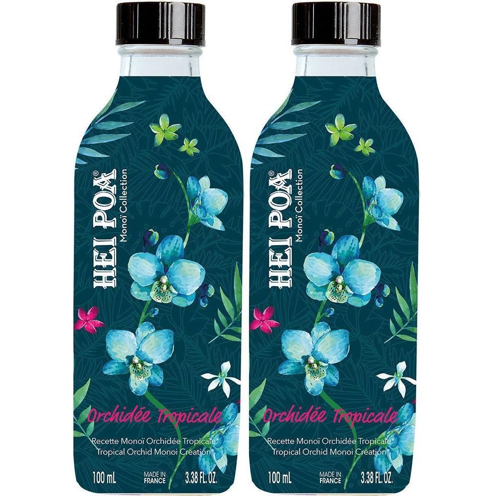 Deux bouteilles d'huile Hei Poa Orchidée Tropicale avec des fleurs et feuilles tropicales sur une étiquette bleu foncé.